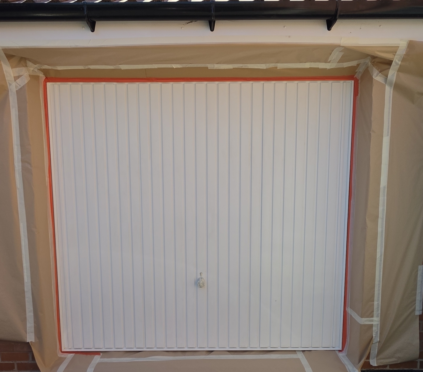 Before: white up-and-over garage door
